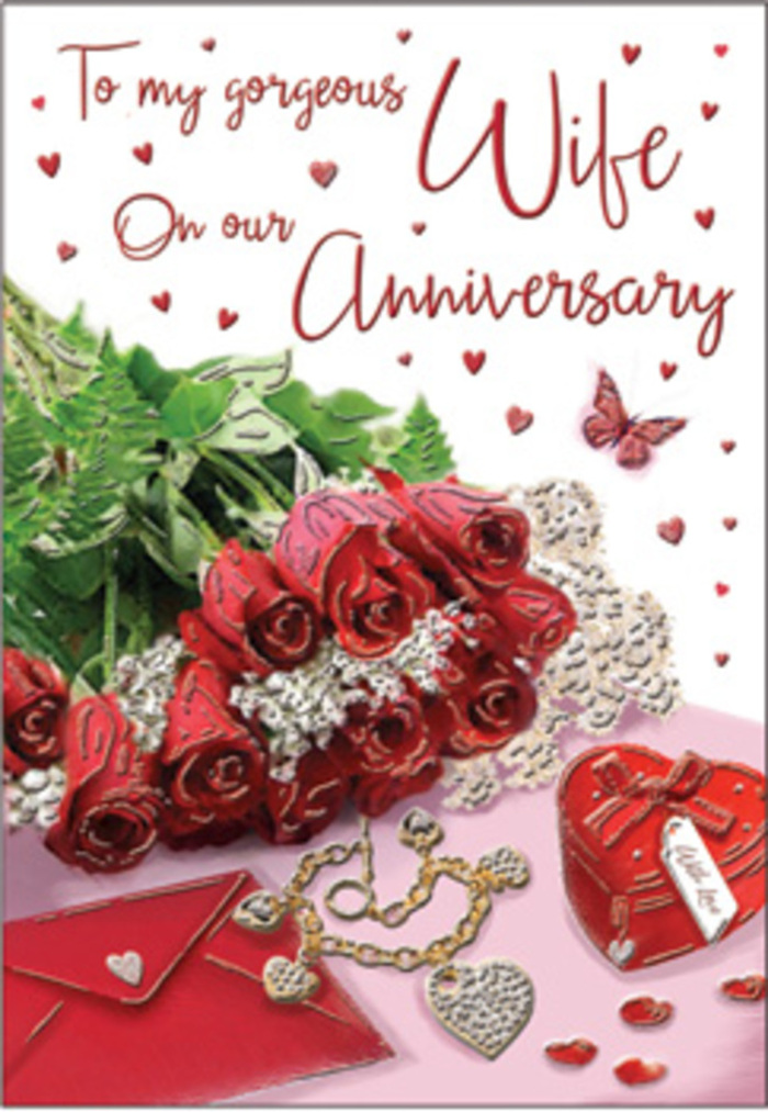 A richly romantic anniversary tableau stretches across the image, composed with the same care and attention you might expect from a long-established South Croydon florist. At its centre, a bouquet of classic red roses sits proudly, each bloom perfectly open and full, petals layered in spirals of deep ruby that suggest both passion and reassurance. The roses are gathered with lush green foliage, their stems and leaves forming a natural frame that feels as organic as the greenery in nearby Park Hill. The bouquet is positioned alongside an elegant anniversary card and a neatly tucked envelope, their soft cream and white tones providing a calm backdrop for the vivid flowers. Around them, small treasures are arranged with deliberate grace: a matching jewellery set with a golden gleam, a vivid red gift box hinting at a surprise tucked within, and a delicate heart-shaped trinket that adds a personal, keepsake touch. Fine lace-like textures and subtle heart patterns peek through the composition, suggesting fabrics and ribbons you might choose when wrapping an anniversary gift at home off Pampisford Road. Gentle lighting glows across the scene, pooling on the petals and metallic details, creating highlights that make each element stand out yet still harmonise together. The atmosphere is undeniably romantic but also comforting, like an evening spent revisiting old photographs or walking hand-in-hand through the local streets. Every detail combines to honour the kind of love that deepens over years, making this image ideal for celebrating another cherished chapter in a South Croydon couple's story.